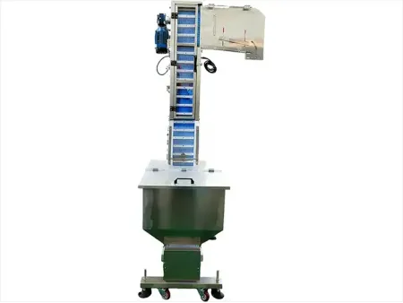 Elevatore e alimentatore automatico di tappi